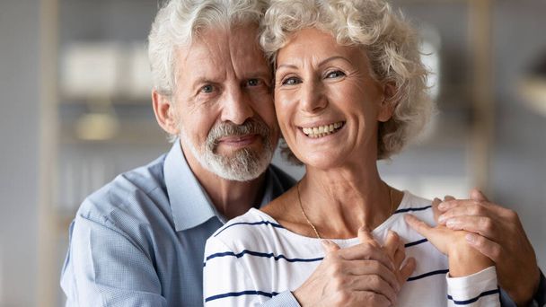 Portrait of happy mature couple hug showing love and care - Photo, image