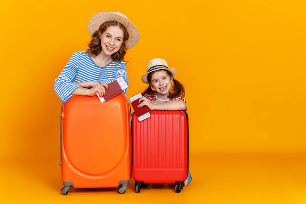 Jó utat! utazók családja anya és gyermek bőröndökkel jegyek és útlevelek színes sárga backgroun - Fotó, kép