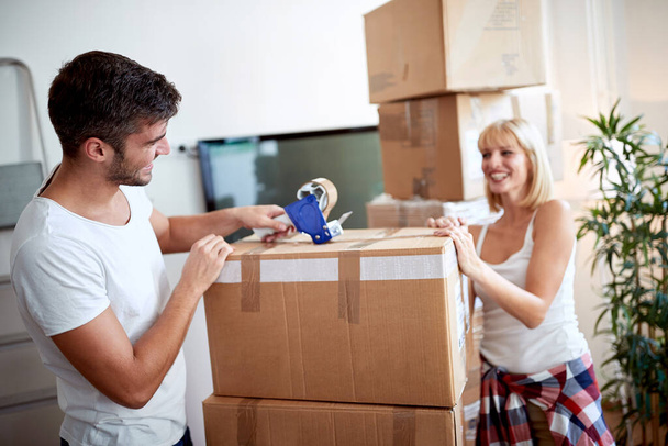 young couple packing things for moving.  moving, new beginning, concept - Фото, изображение