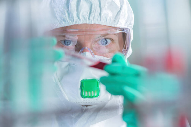 Virologist healthcare professional analyzing blood test sample in lab tubes, close up of medical worker working, selective focus - Foto, Bild