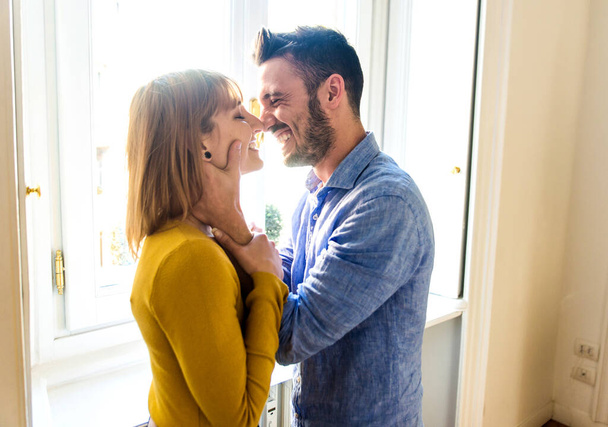 Two young adults at home - Romantic moment at home, couple of lovers kissing - Foto, immagini