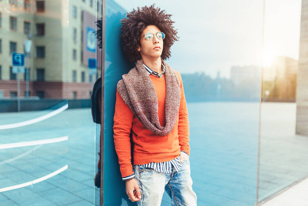 Stylish mixed race man, great design for any purposes. young student guy. Youth lifestyle. Walking on the summer city stereet and have fun - 写真・画像