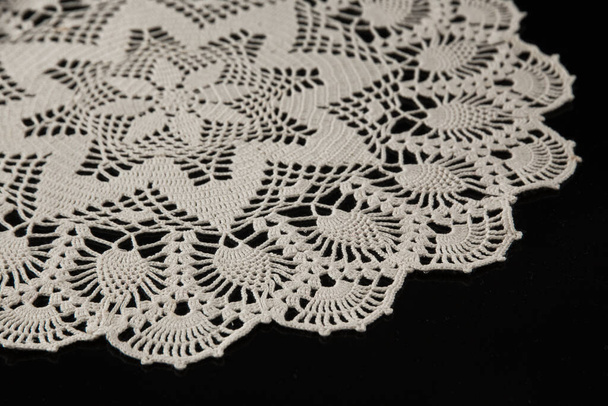 crocheted napkins, white lace on a black background - Φωτογραφία, εικόνα