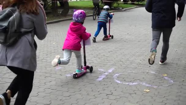 LVIV, UKRAINE - SEPTEMBER 21, 2019: Children 's cycling in the city park. Slow motion. - 映像、動画
