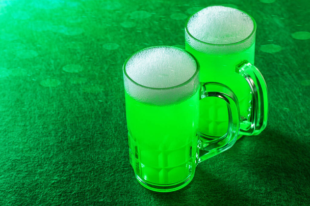 St. Patrick 's Day vieren. Groen bier op de groene achtergrond close-up, geïsoleerd.  - Foto, afbeelding