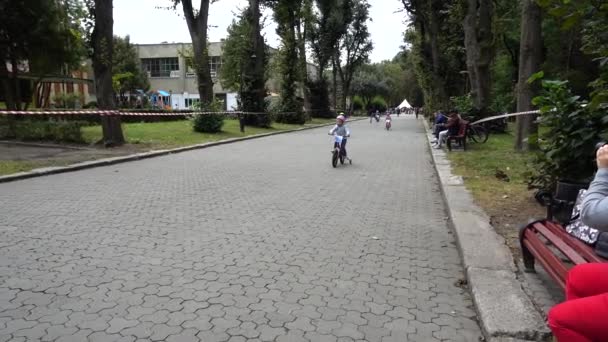 LVIV, UKRAINE - SEPTEMBER 21, 2019: Children 's cycling in the city park. Slow motion. - Video