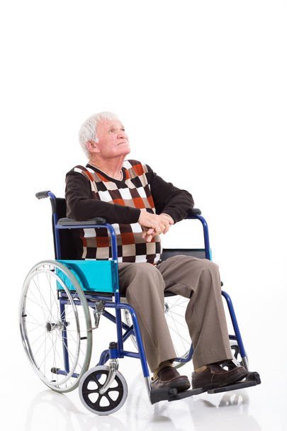 thoughtful senior man on a wheelchair looking up - Zdjęcie, obraz
