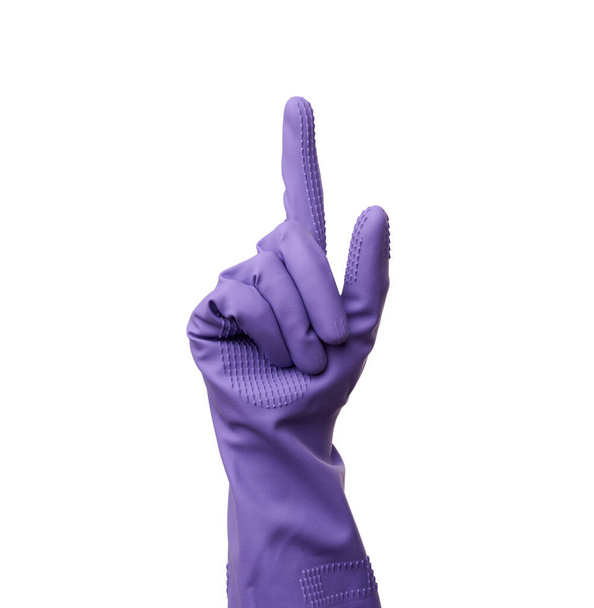purple rubber glove for cleaning is dressed on the hand, protection of the hands from chemicals, index finger raised, isolated white background - Fotografie, Obrázek