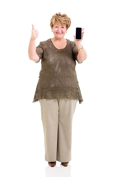 senior woman holding smart phone and giving thumb up - 写真・画像