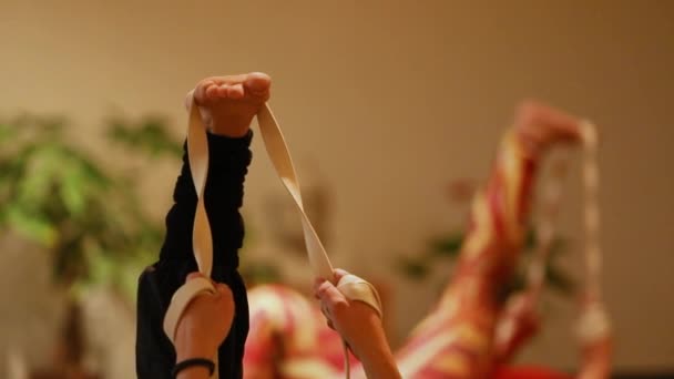 Woman using stretch band for leg exercise - Video, Çekim