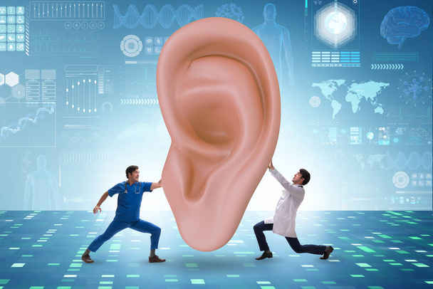 Doctor examining giant ear in medical concept - Photo, Image