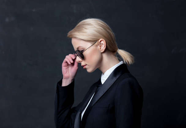 Style businesswoman in a classic black business suit and sunglasses - Foto, imagen