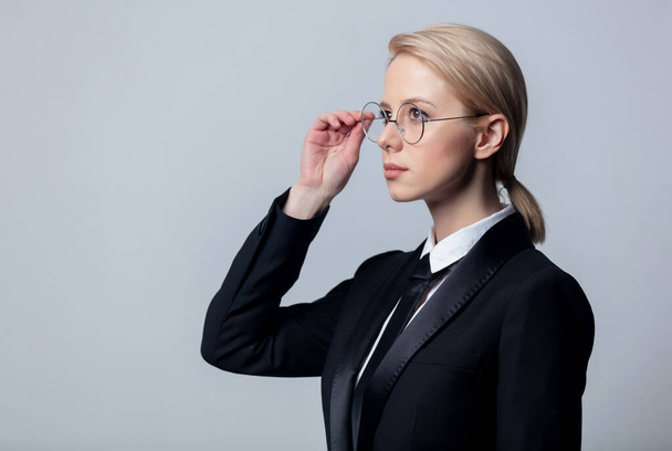 Style businesswoman in a classic black business suit and glasses - Photo, Image