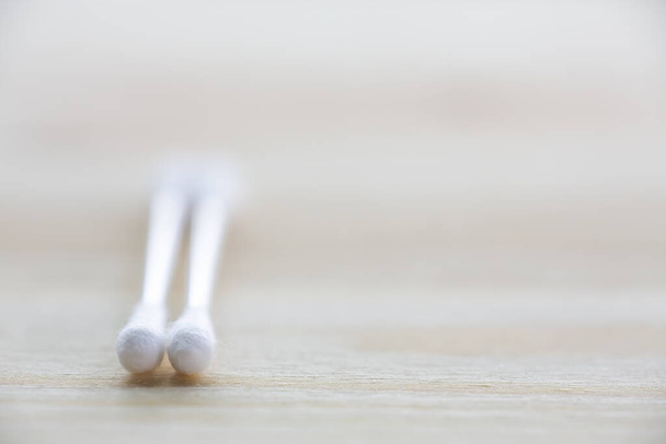 Two white plastic cotton buds on wood table texture background, Close up & Macro shot, Selective focus, About Cleaning Body, Healthcare concept - Foto, Bild