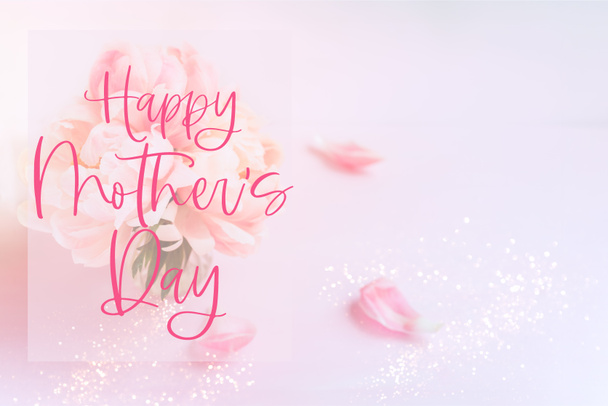 Happy Mother's Day phrase. Fresh bunch of pink peonies and roses in a vase on pink background. Card concept, pastel colors, copy space - Photo, Image