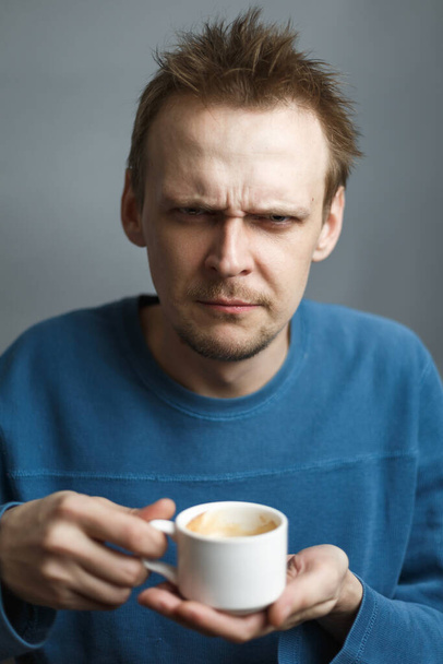 Moody man hold cup of coffee - Фото, зображення