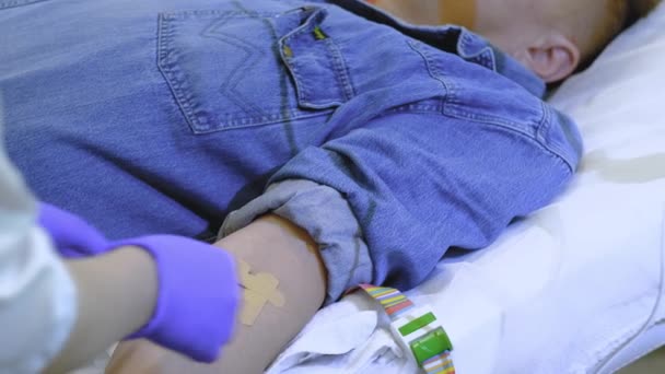 a man in a denim suit is given an intravenous infusion - Filmmaterial, Video