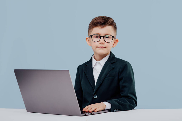Young business boy. with glasses using a laptop, - Zdjęcie, obraz