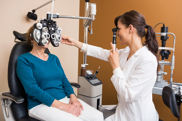 Optometrist Examining Senior Woman's Eyes - Zdjęcie, obraz