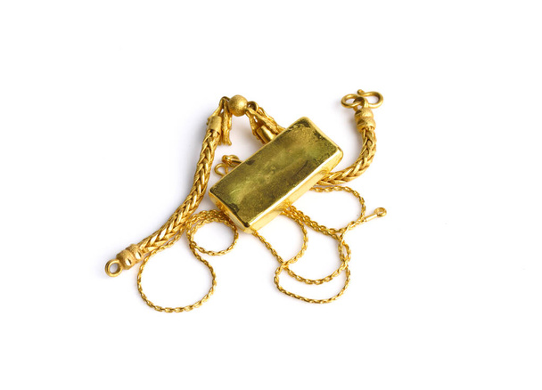 gold chain and gold bar on a white background - Foto, Bild