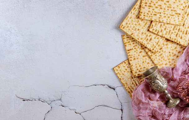 Matzah bread with kosher kiddush and flowers. Jewish Passover holiday concept. - Photo, Image