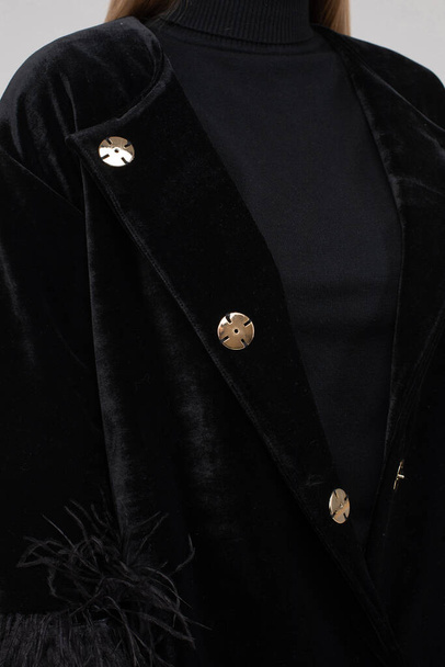 Crop of a model in fashionable black coat. - 写真・画像