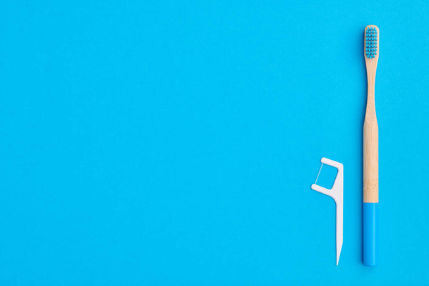Toothbrush on blue background top view copy space. Tooth care, dental hygiene and health concept.  - 写真・画像