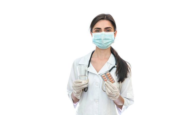 Doctor in mask holding pills in blister isolated on white - Fotó, kép