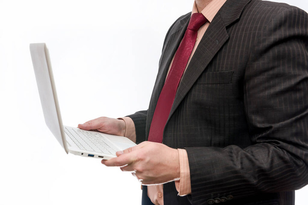 Mies puvussa kannettava tietokone valkoisella taustalla
 - Valokuva, kuva