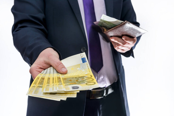 Man holding wallet and offering euro banknotes - Photo, image