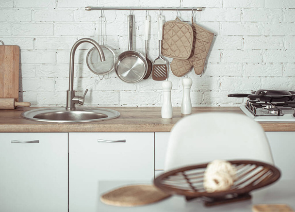 Modern stylish Scandinavian kitchen interior with kitchen accessories. Bright white kitchen with household items . - Zdjęcie, obraz