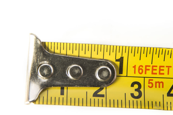 Closeup of meter tape in centimeters and inches on the white background - Photo, Image