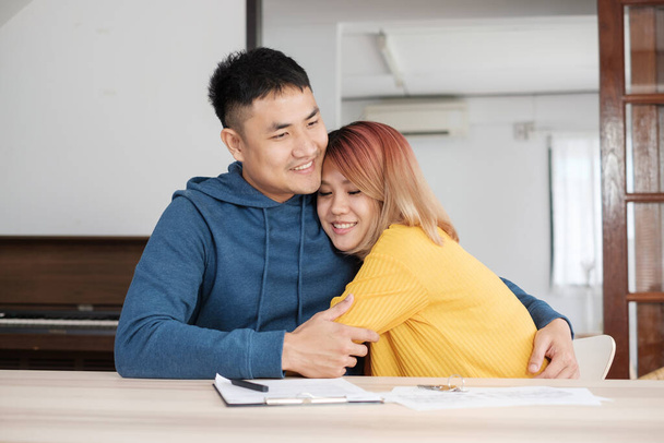 Asian happy couple buying new home with realtor agent with smiling face at new home.buying new house real estate - Valokuva, kuva