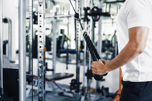 A man training triceps in the gym - Фото, зображення