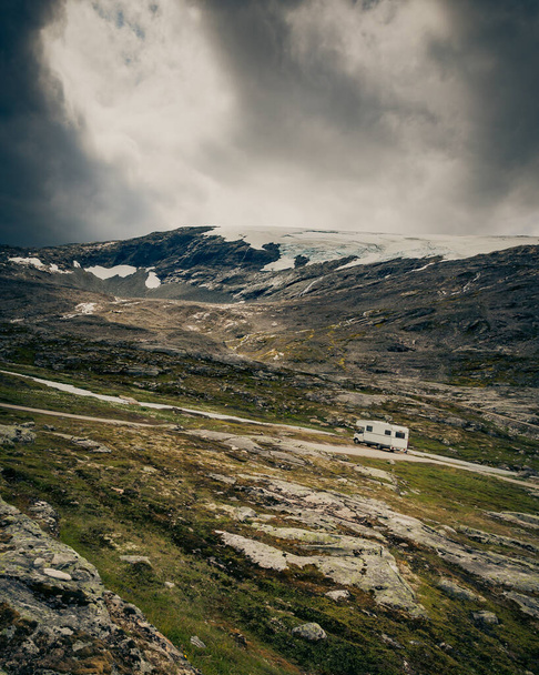 Camper car in norwegian mountains. Camping on nature. Traveling, holidays and adventure concept. - Foto, Bild
