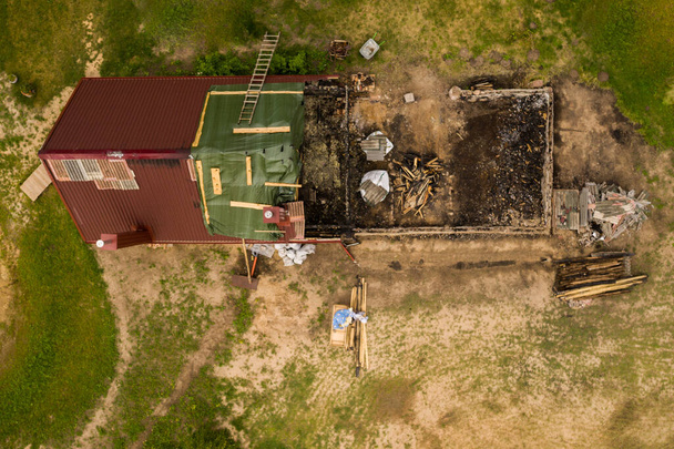 Drone point of view of half burned down house. - Photo, Image