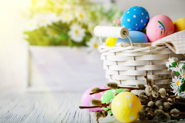 Happy Easter. Congratulatory easter background. Easter eggs and flowers. Background with copy space. Selective focus. - Photo, Image