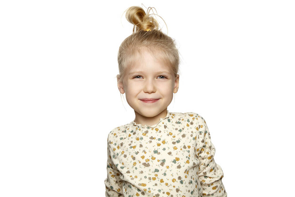 Simple portrait of cute little blonde girl on white background. - Photo, Image