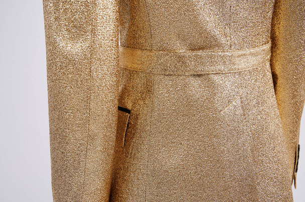 Person in golden jacket. Luxury stylish classic clothes. Made of lurex thread. Individual tailoring. Closeup. - Foto, Imagen