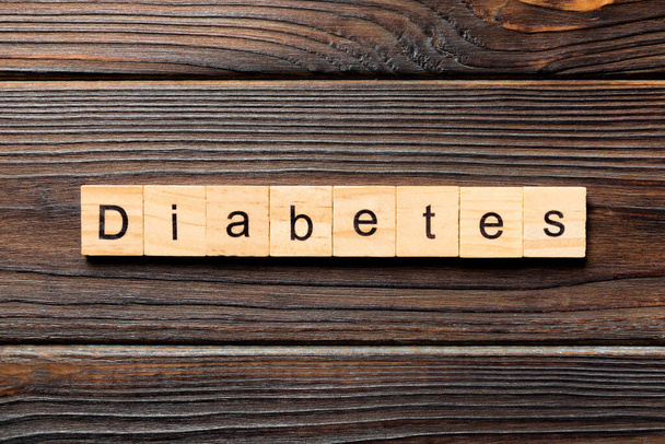 Diabetes word written on wood block. Diabetes text on wooden table for your desing, Top view concept. - 写真・画像