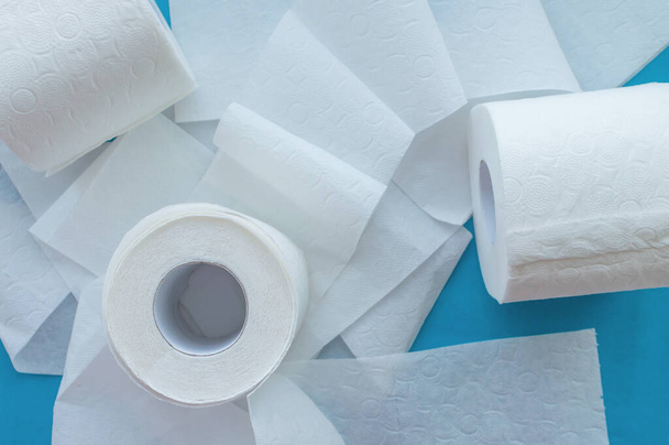 Rolls of white toilet paper on a blue background. Close up. The view from the top. - Fotoğraf, Görsel
