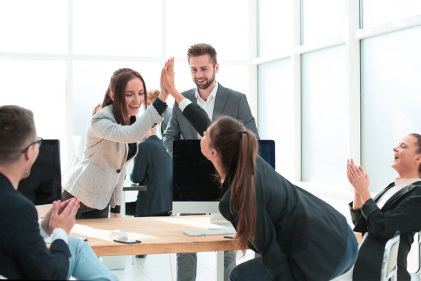 young employees giving each other a high five - Photo, image