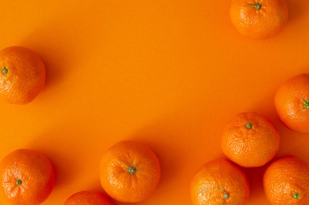 organic tangerines on orange background with copy space. Top view - 写真・画像