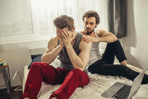 offended gay and his partner soothing him - Valokuva, kuva