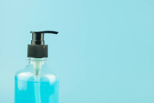 wash hand sanitizer gel bottle on blue background, against Novel coronavirus or Corona Virus Disease (Covid-19). Antiseptic, Hygiene and Healthcare concept - Fotoğraf, Görsel