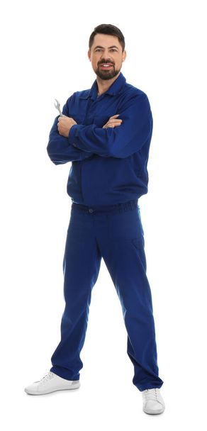 Full length portrait of professional auto mechanic with wrench on white background - Fotografie, Obrázek