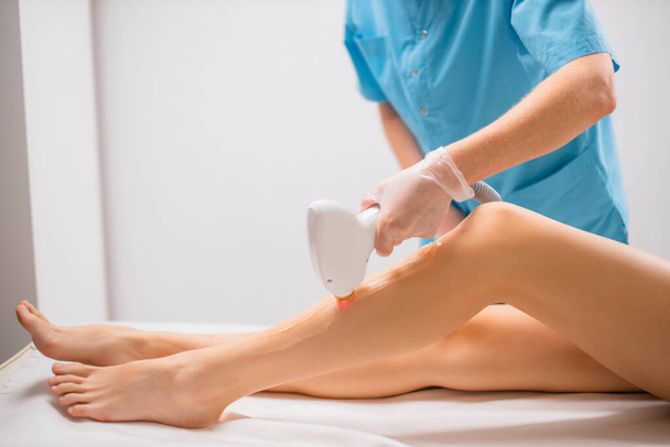 young slim woman get epilation procedure in beauty salon - Fotoğraf, Görsel