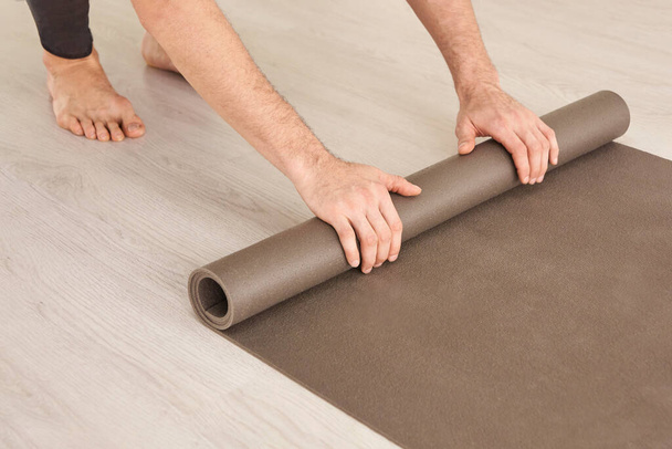 Yoga person rolling sport mat. Grey color. Gym carpet - Zdjęcie, obraz