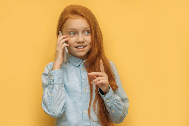 beautiful red haired girl talking on phone - Photo, image