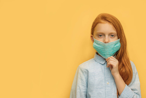 red haired girl with mask on face, coronavirus - Zdjęcie, obraz